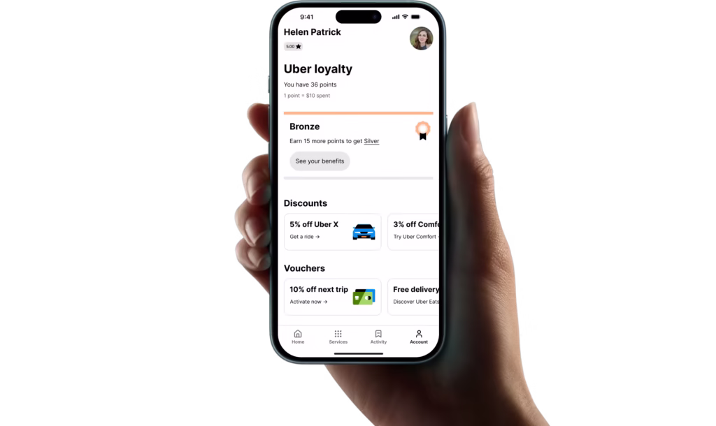 person holding a phone with the uber app opened on the loyalty program page